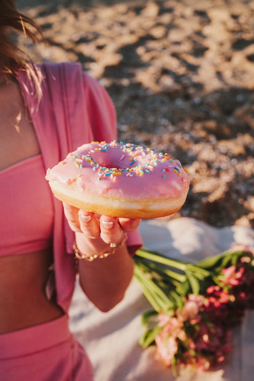 Close-up of Woman Holding a Donut 