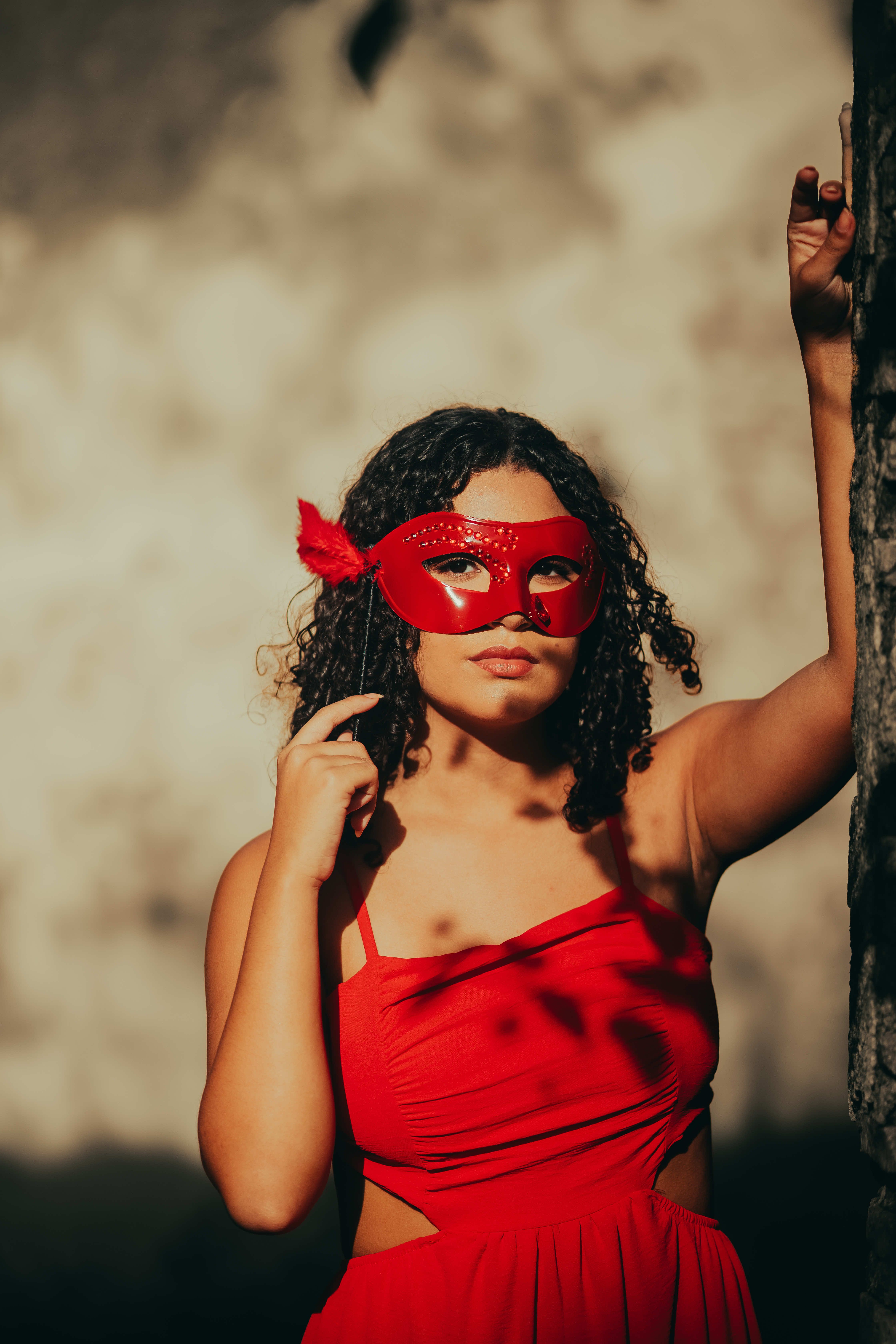 Woman in a Red Dress Holding a Carnival Mask  Free Stock Photo
