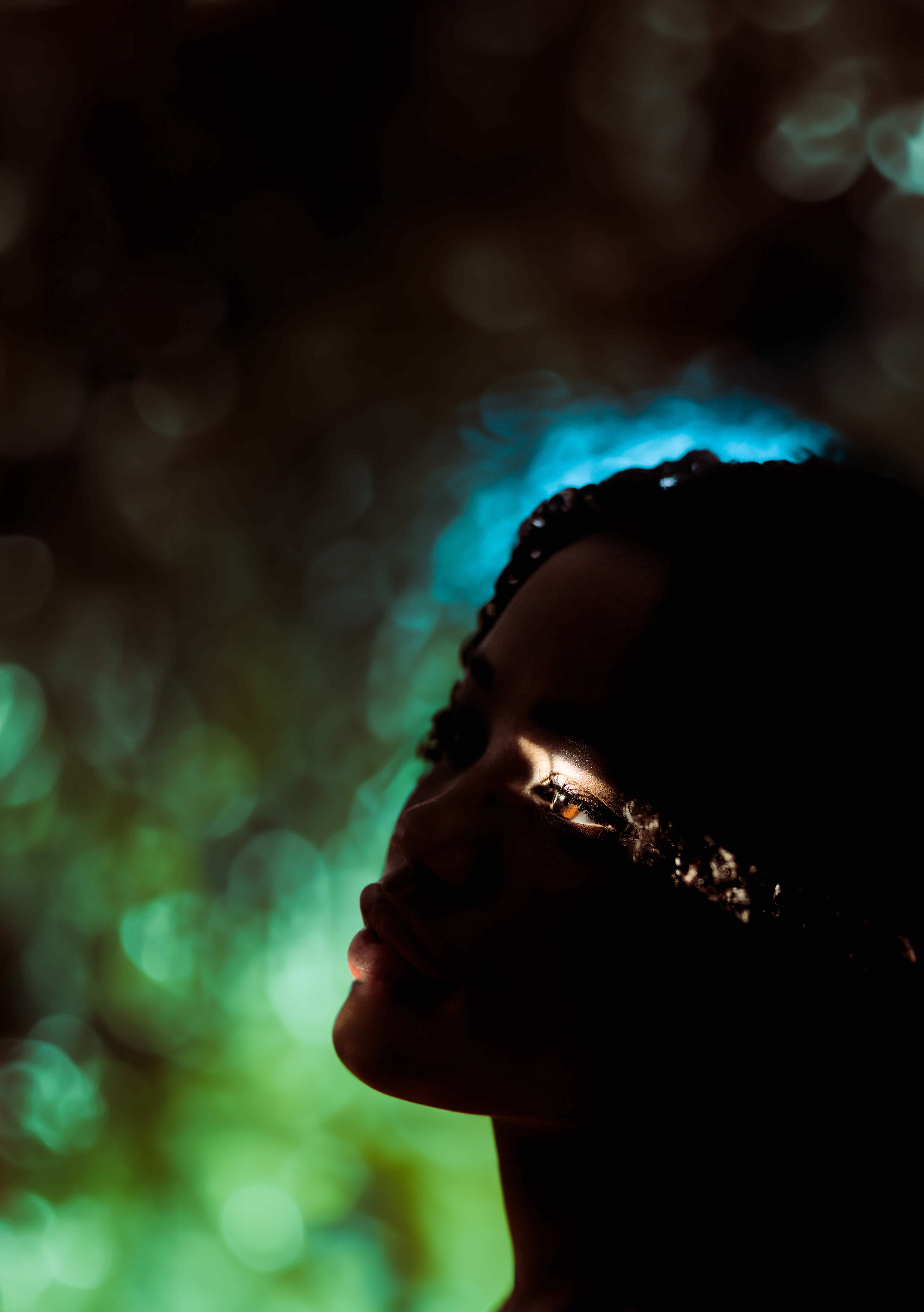 Dramatic artistic portrait highlighting the eye of an African woman, captured with creative lighting.