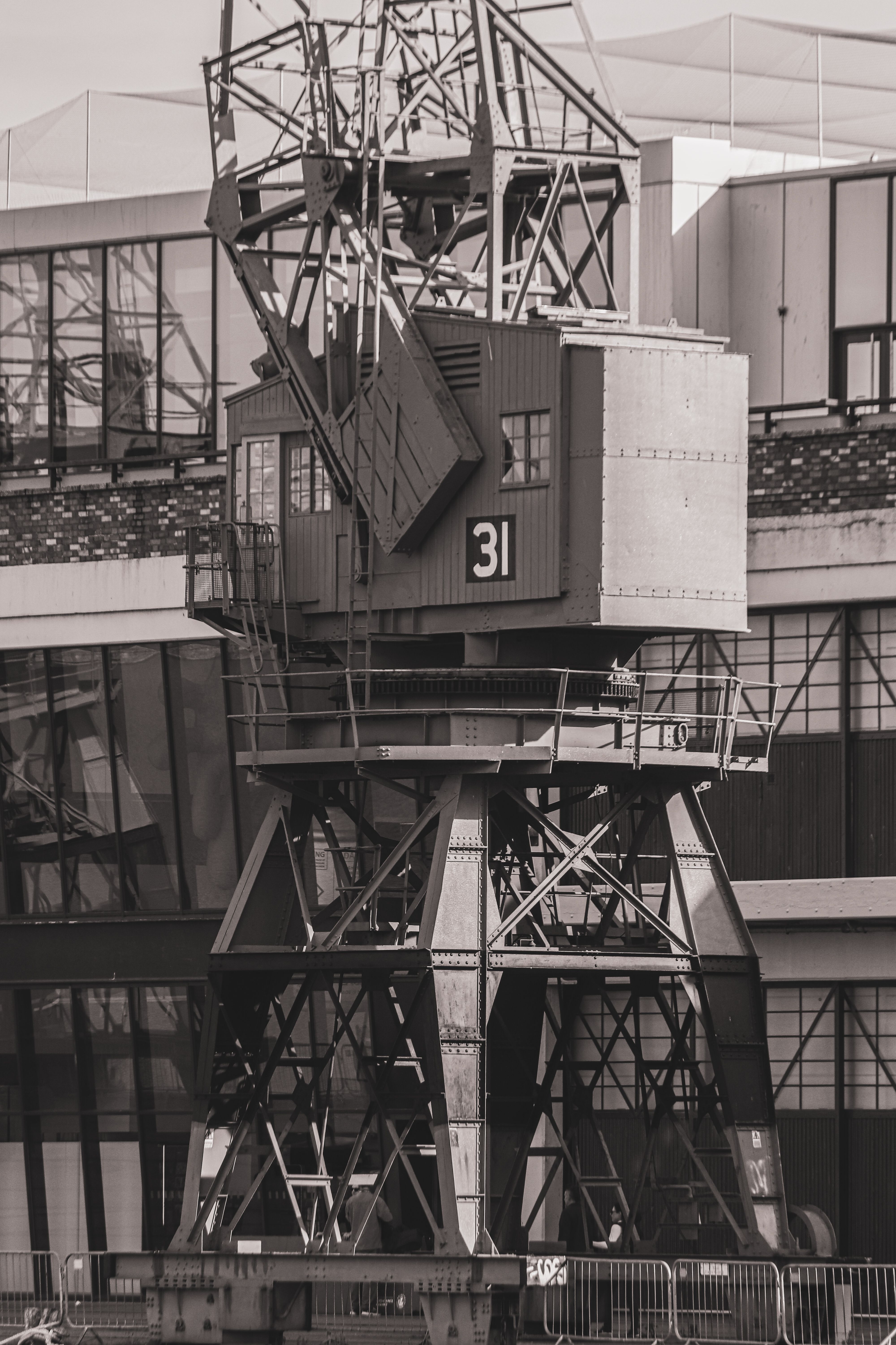 Black and white photo of an industrial crane at Bristol Harbor with a historic feel.