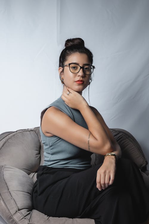 Elegant Woman Sitting on Grey Sofa