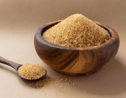 Studio Shoot of Brown Sugar on Wooden Spoon and in a Wooden Bowl