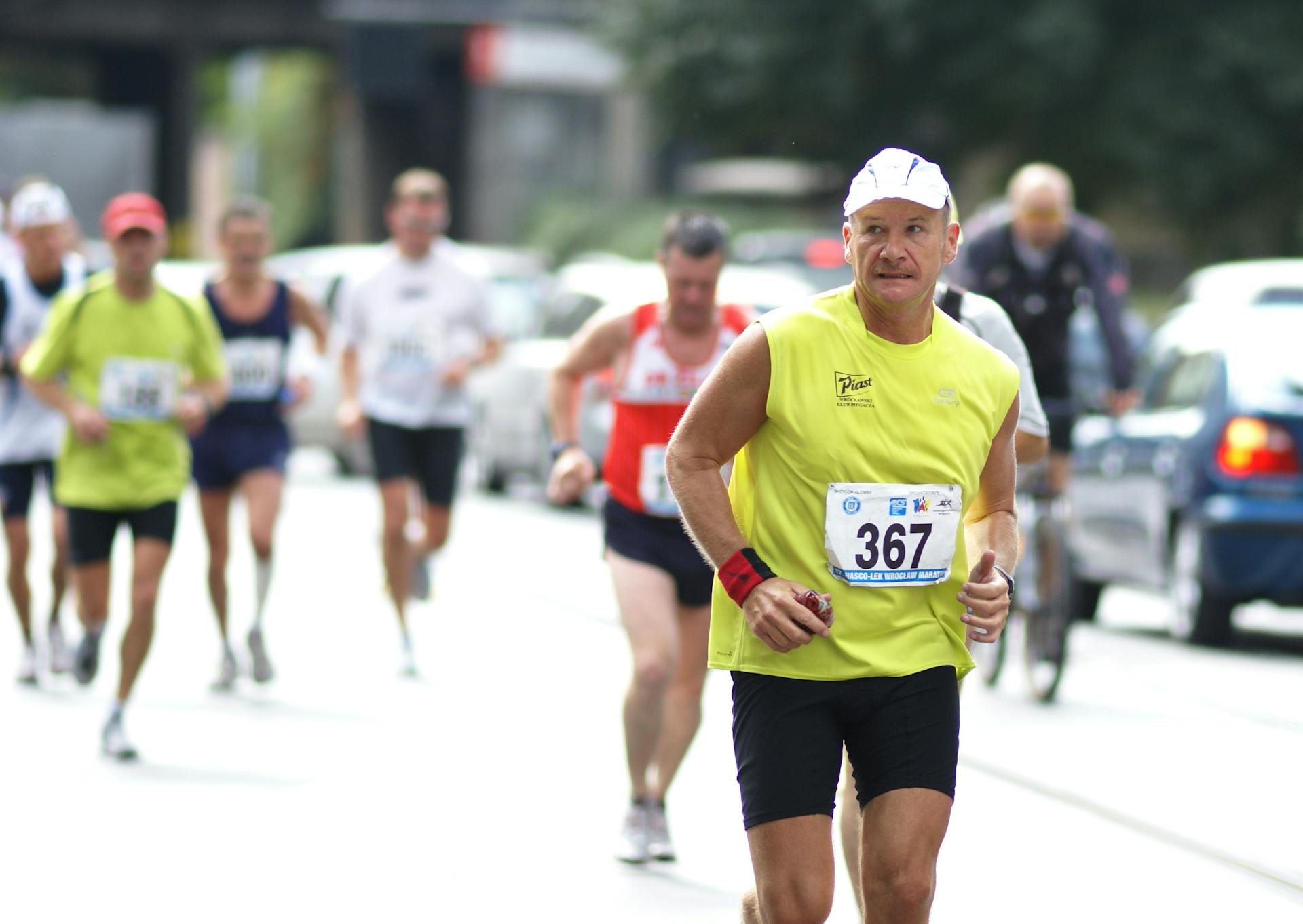 A man running in a marathon with other runners