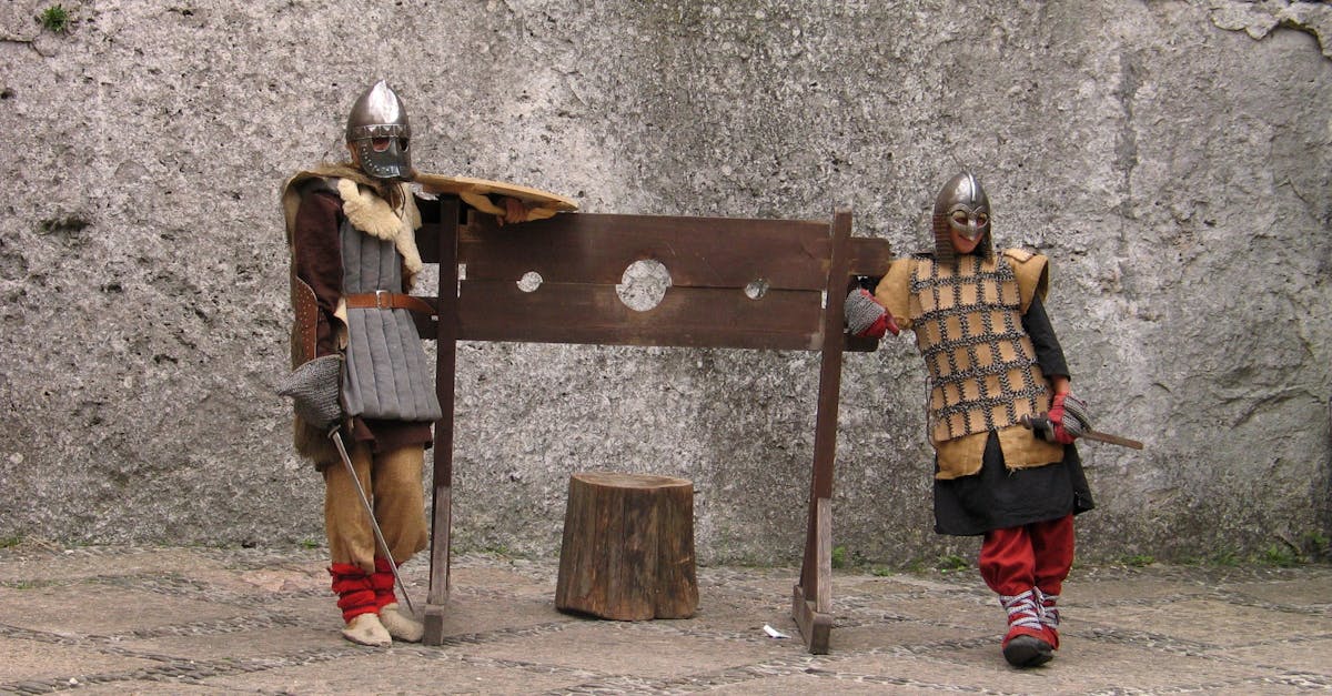 Photo of People Wearing Medieval Costumes, Posing with a Guillotine