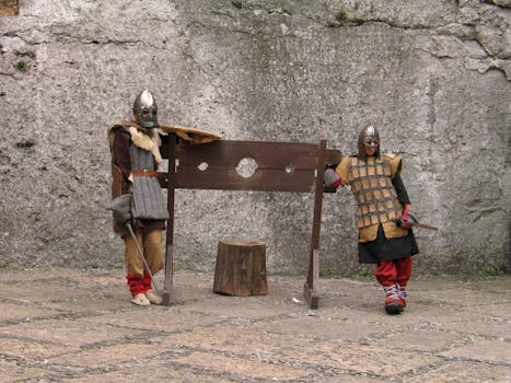 Two medieval knights in armor posing with stocks outdoors, showcasing historical costumes.