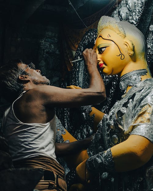 Man Painting Durga Statue