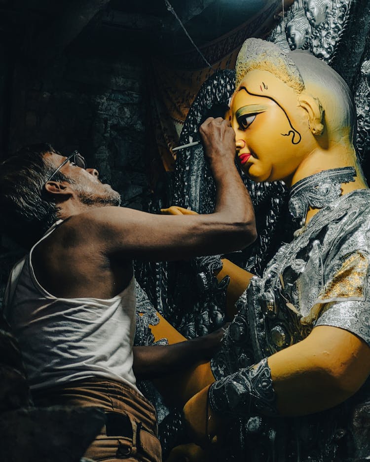 Man Painting Durga Statue