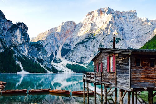 Wooden House by Lake in Dolomites in Italy