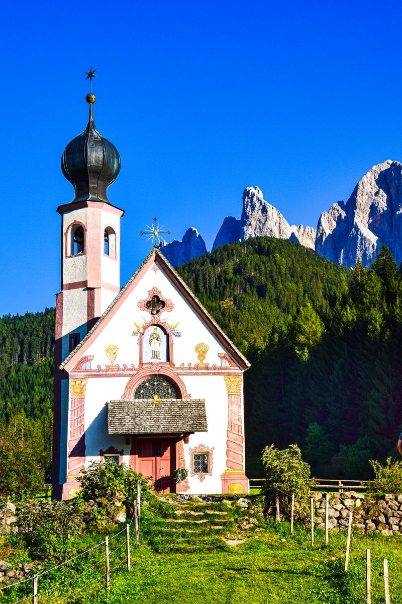 The Church of St. John set against the Dolomite peaks