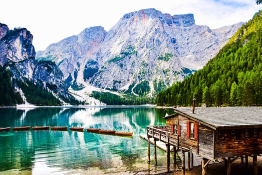 Beautiful view of a mountain lake and wooden cabin in the Italian Dolomites, ideal for travel inspiration.