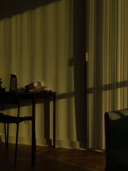 A tranquil room in Toronto with soft shadows and gentle light filtering through blinds.