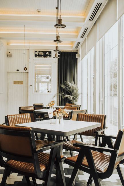 Stylish café interior with modern furniture in Ankara, featuring minimalist design and ambient lighting.