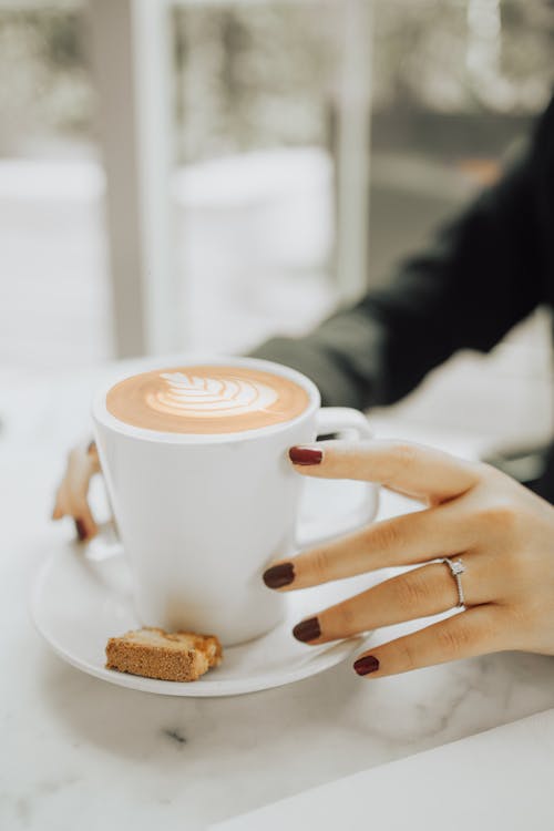 Woman Hands Holding Cup of Coffee