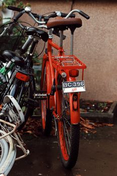 Rear view of a vibrant red bicycle parked against a wall in Jönköping, Sweden.