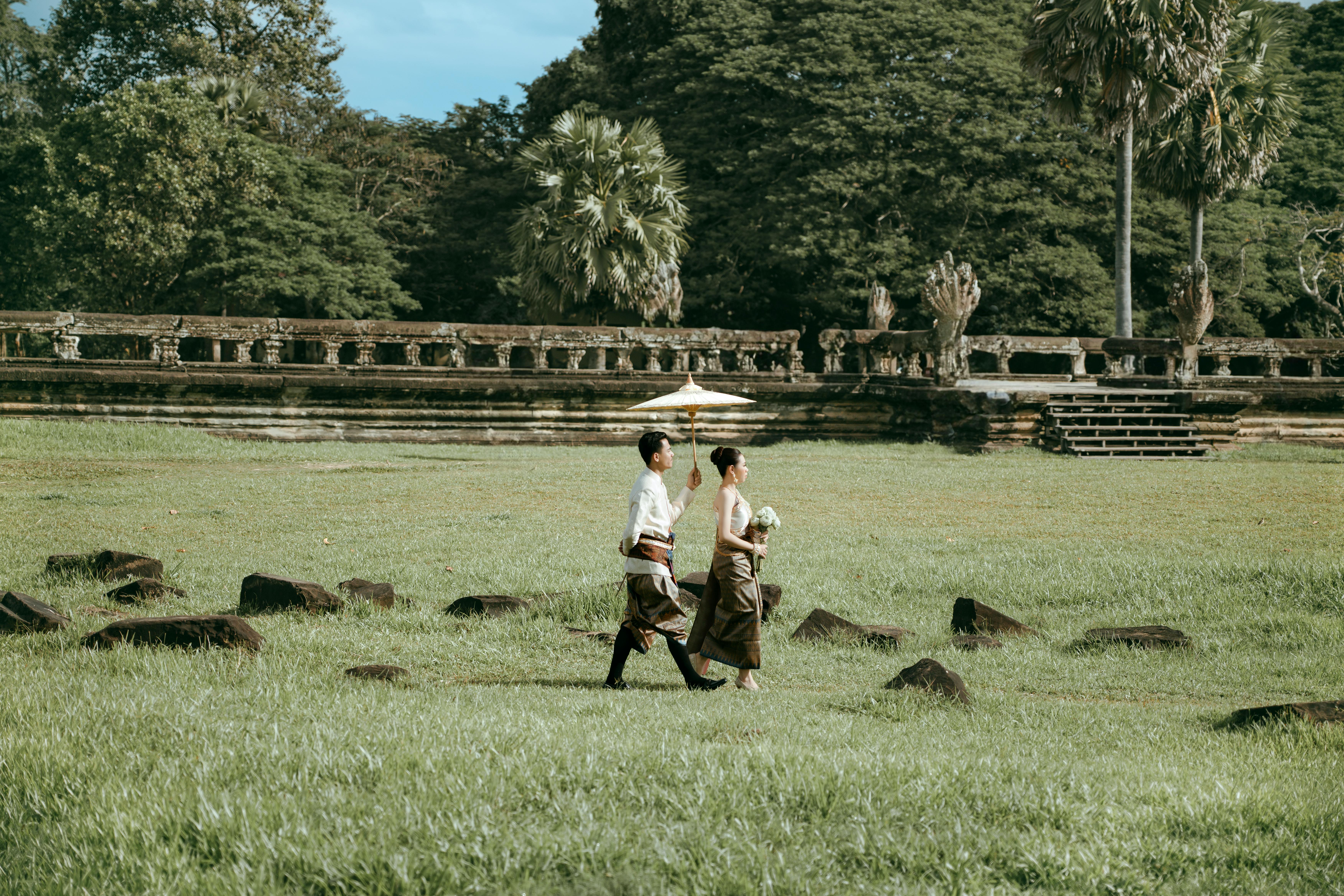 Cambodian wedding couple walking — placeholder for thread tying ceremony