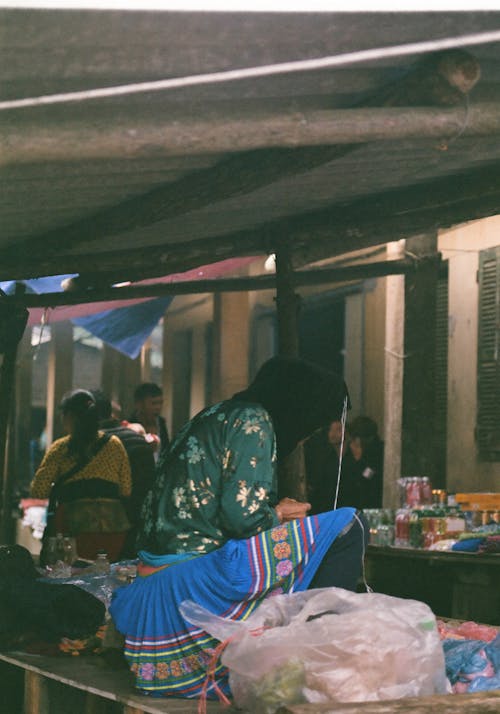 Free Person Sitting on Table on Street Market in Bazaar Stock Photo