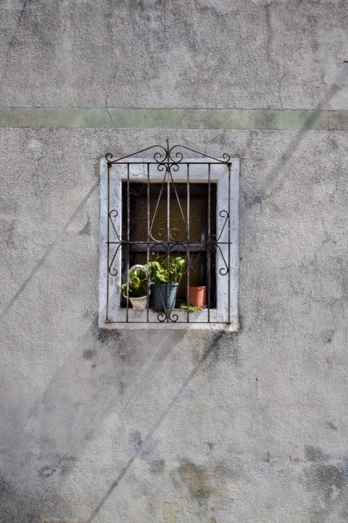 Free Charming retro window with potted plants in Santander, Spain. Ideal for architectural and travel themes. Stock Photo