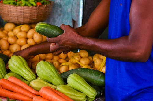 Merchant with Fresh Vegetables on Market
