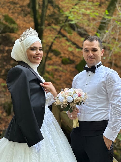 Woman in Crown and Wedding Dress and Man in Shirt Together