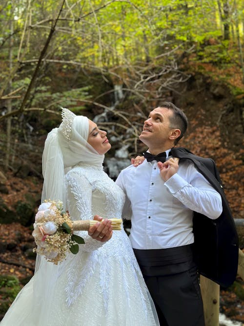 Smiling Newlyweds Together in Forest
