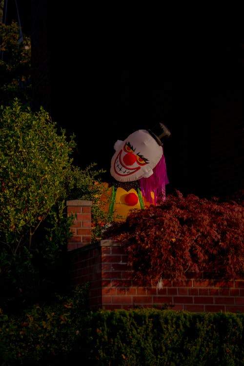 A Scary Inflatable Clown Halloween Decoration on the Yard 