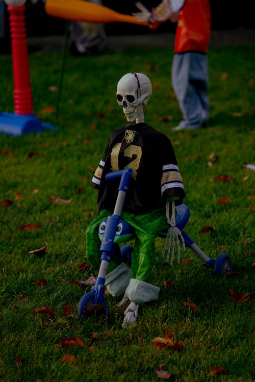 A Skeleton Dressed in Clothes and Sitting on a Bicycle