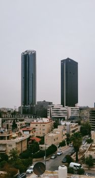Tall skyscrapers amid residential buildings showcasing modern urban architecture.