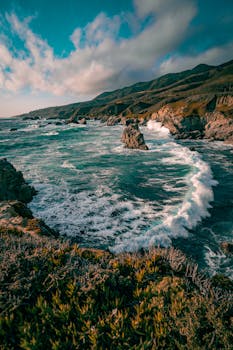 Experience the breathtaking waves and rugged cliffs of Big Sur's iconic coastline in California.