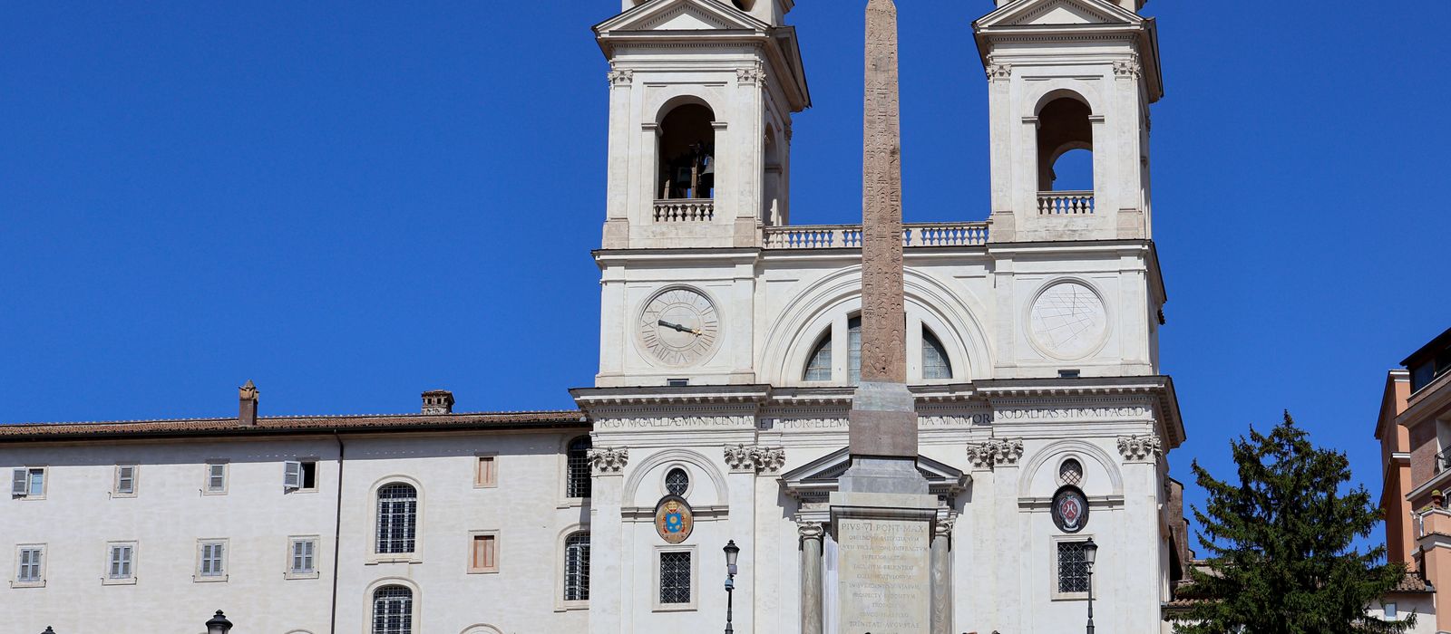 Captivating daytime view of the iconic Trinità dei Monti church in Rome, Italy.