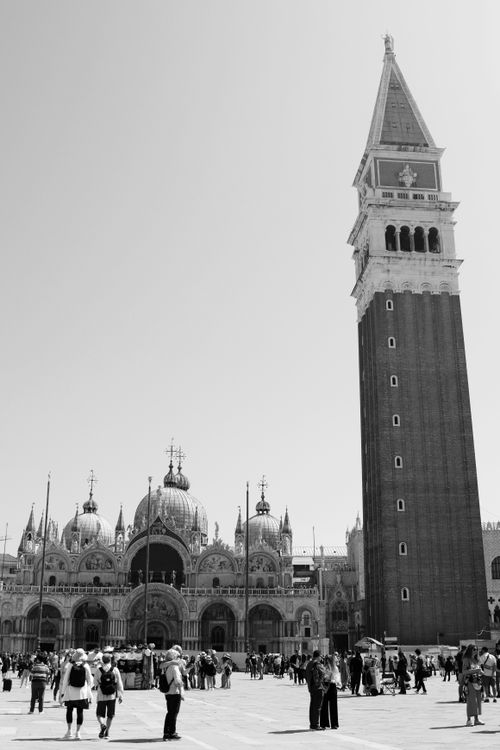 Free A black and white capture of Piazza San Marco showcasing historical architecture and bustling tourism. Stock Photo
