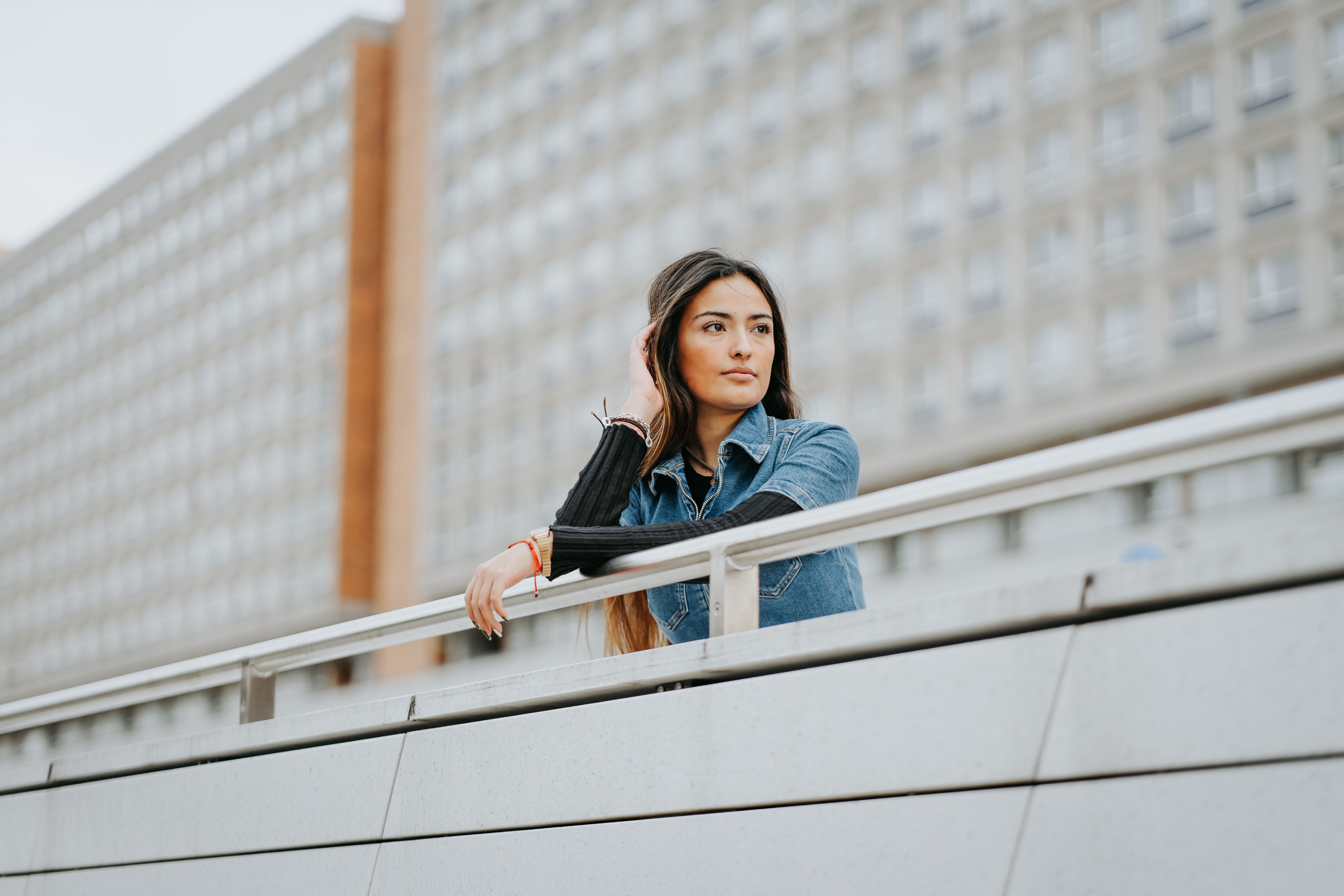 Woman Standing by Railing on Wall · Free Stock Photo