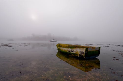 Abandoned Boat on a Lake Covered with Fog 