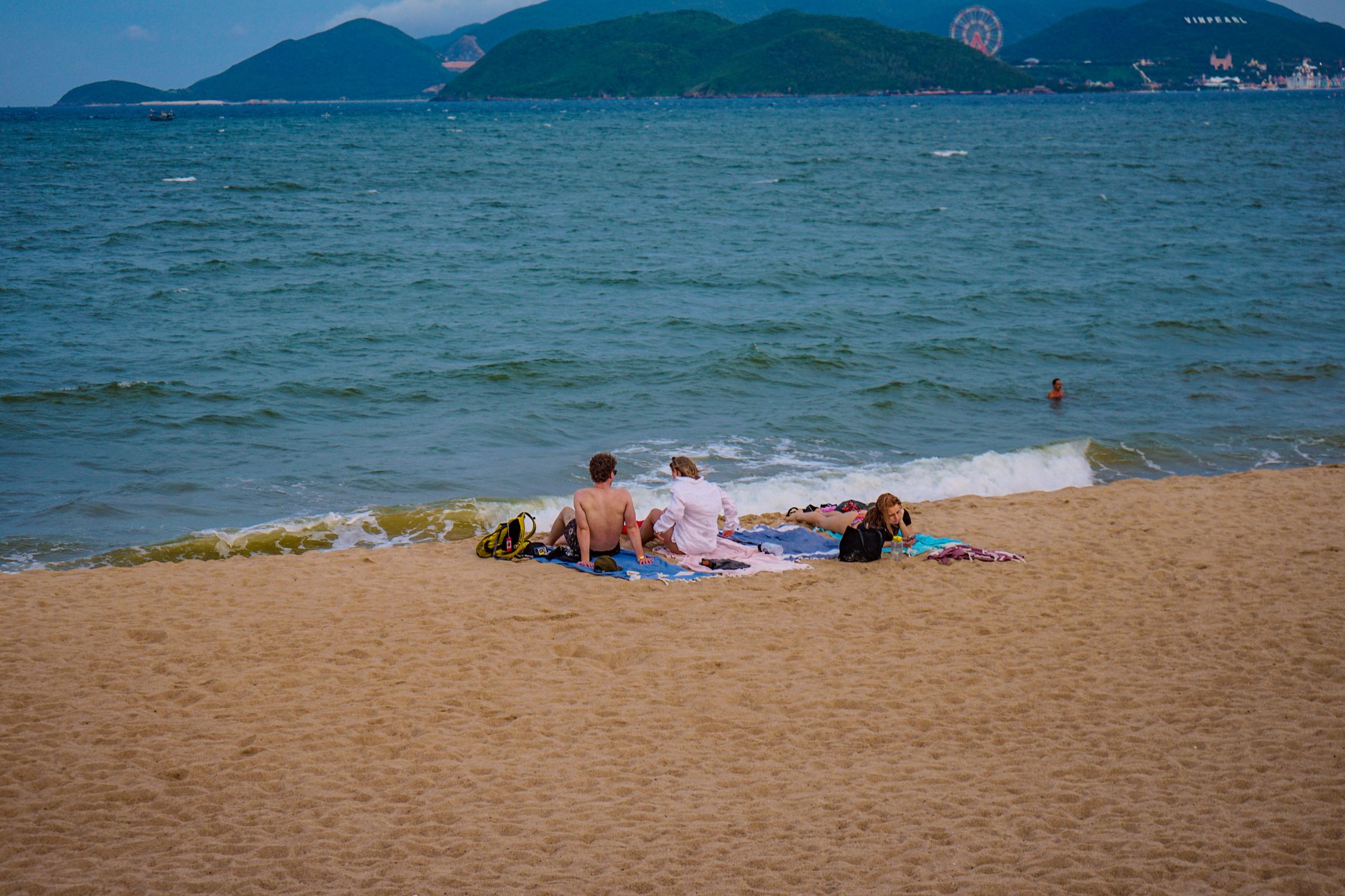 Catch Some Rays Young People Sunbathing on the Sandy Beach · Free Stock Photo