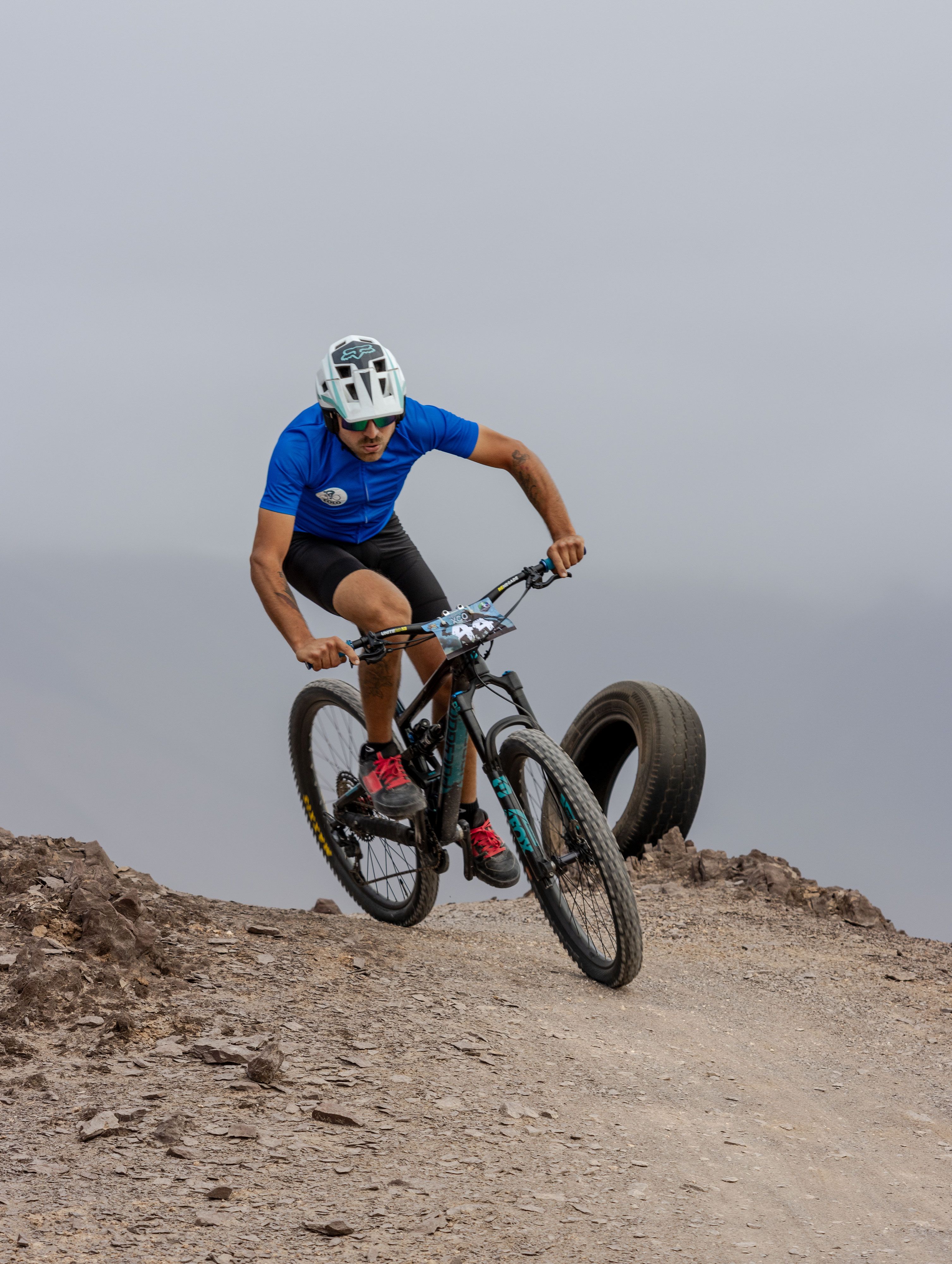 Cyclist races down rugged trail showcasing endurance and skill.
