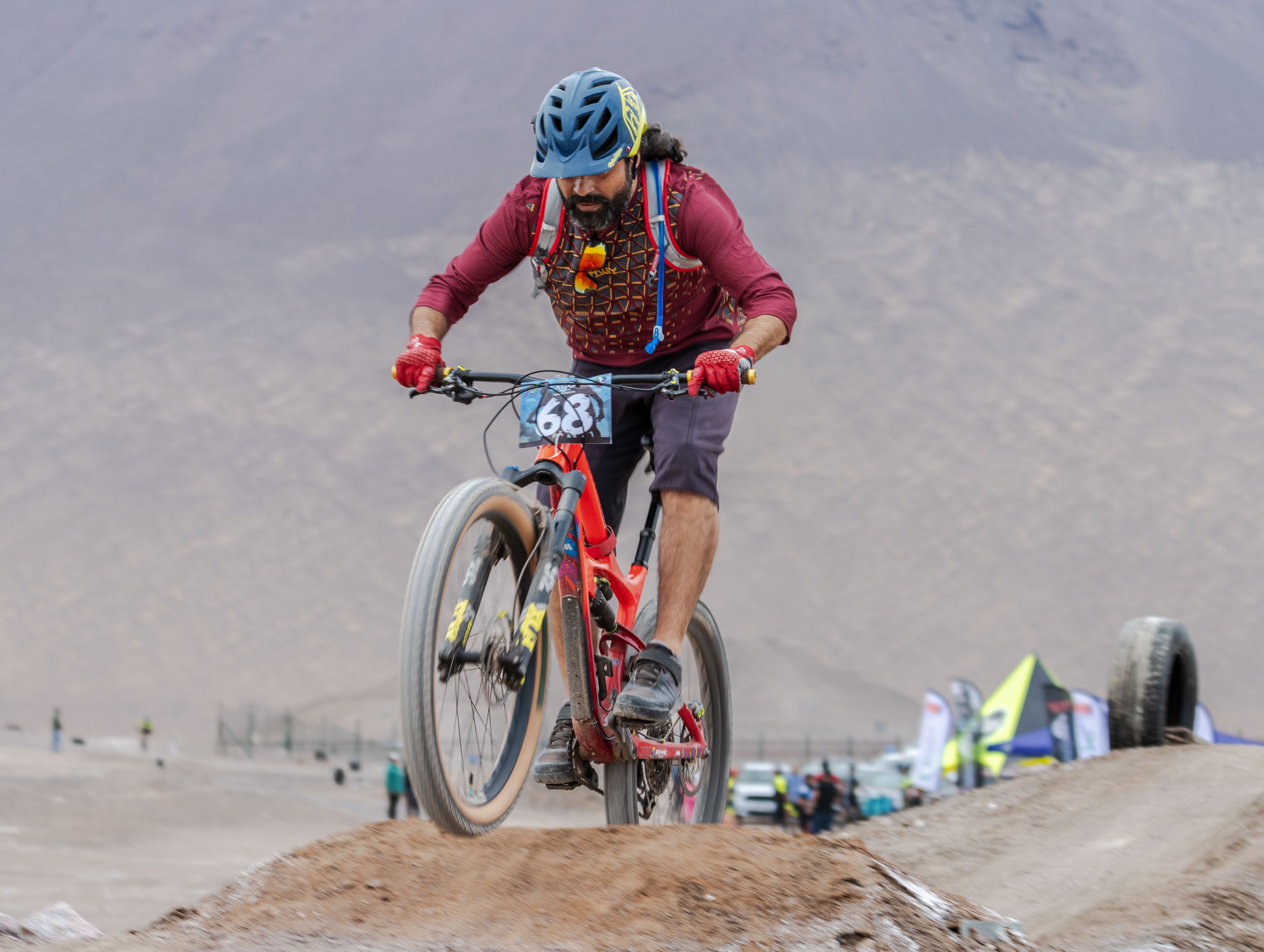 A cyclist tackles rugged terrain during a mountain biking event, showcasing skill and adrenaline.
