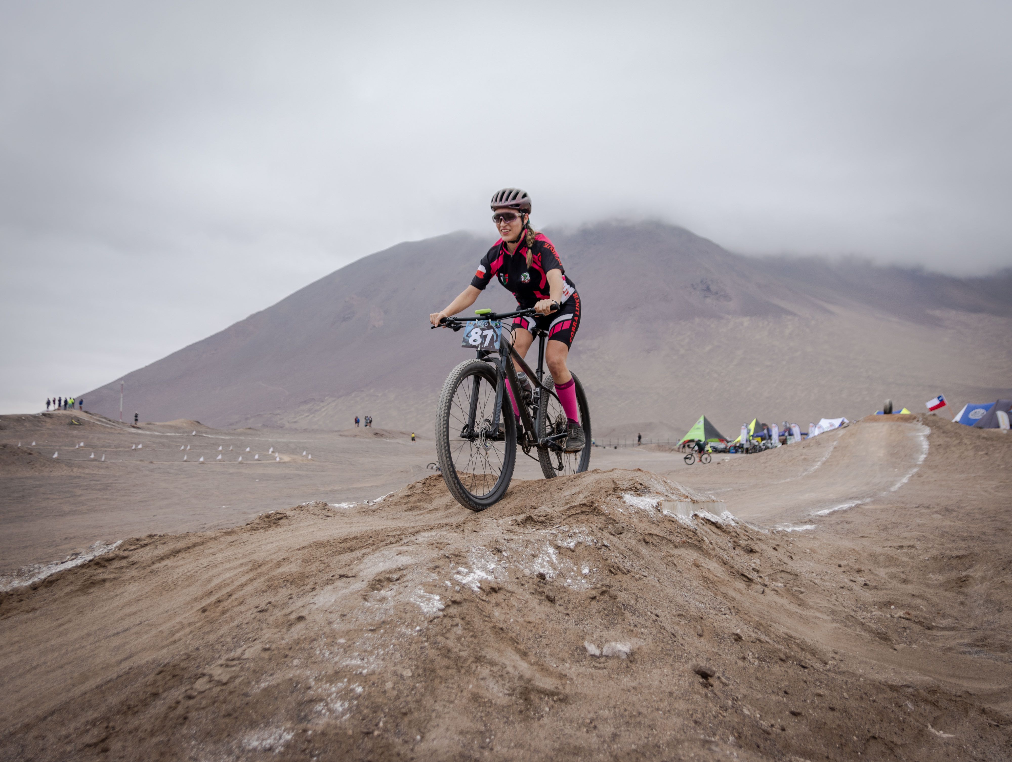 Local athletes training on a dirt track with mountains in the background