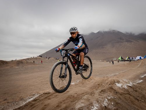 Free Cyclist in sportswear competing in an off-road desert race on a mountain bike. Stock Photo
