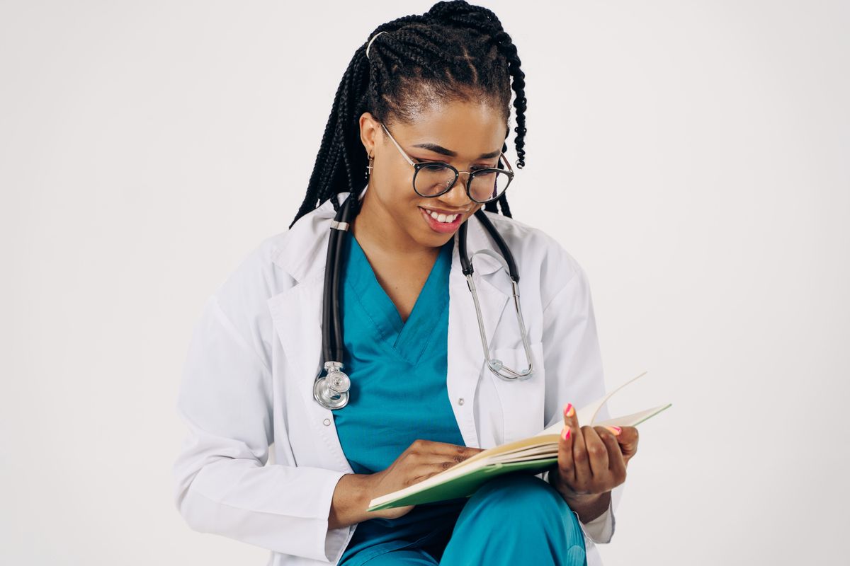A doctor reviewing records and notes