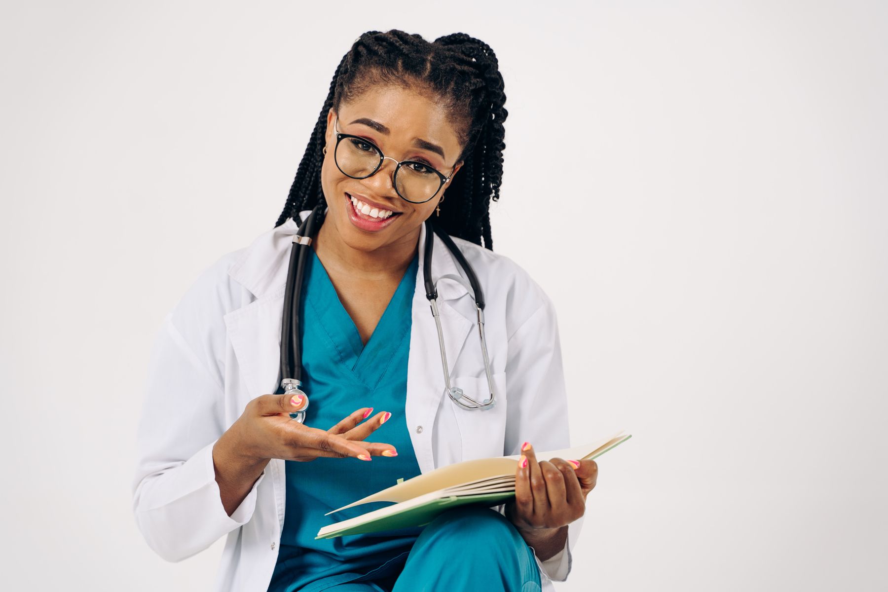 Smiling physician speaking with a patient while reviewing consultation notes