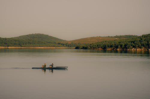 Woman and Man Canoeing on River