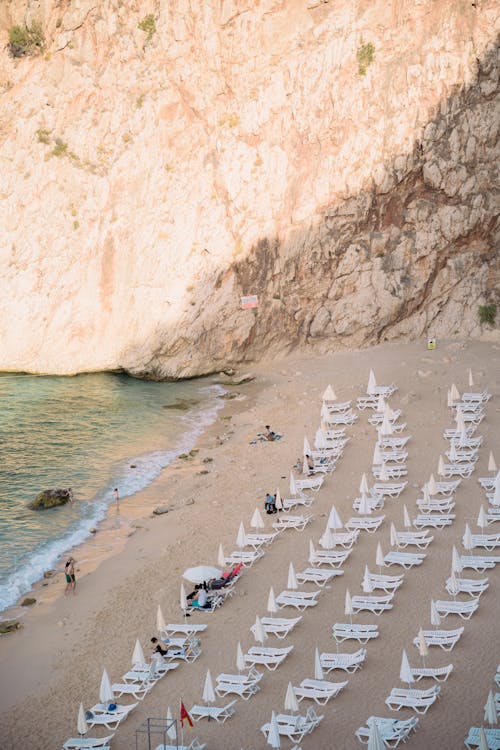 Rows of Sunbeds and Beach Umbrellas on Sea Shore