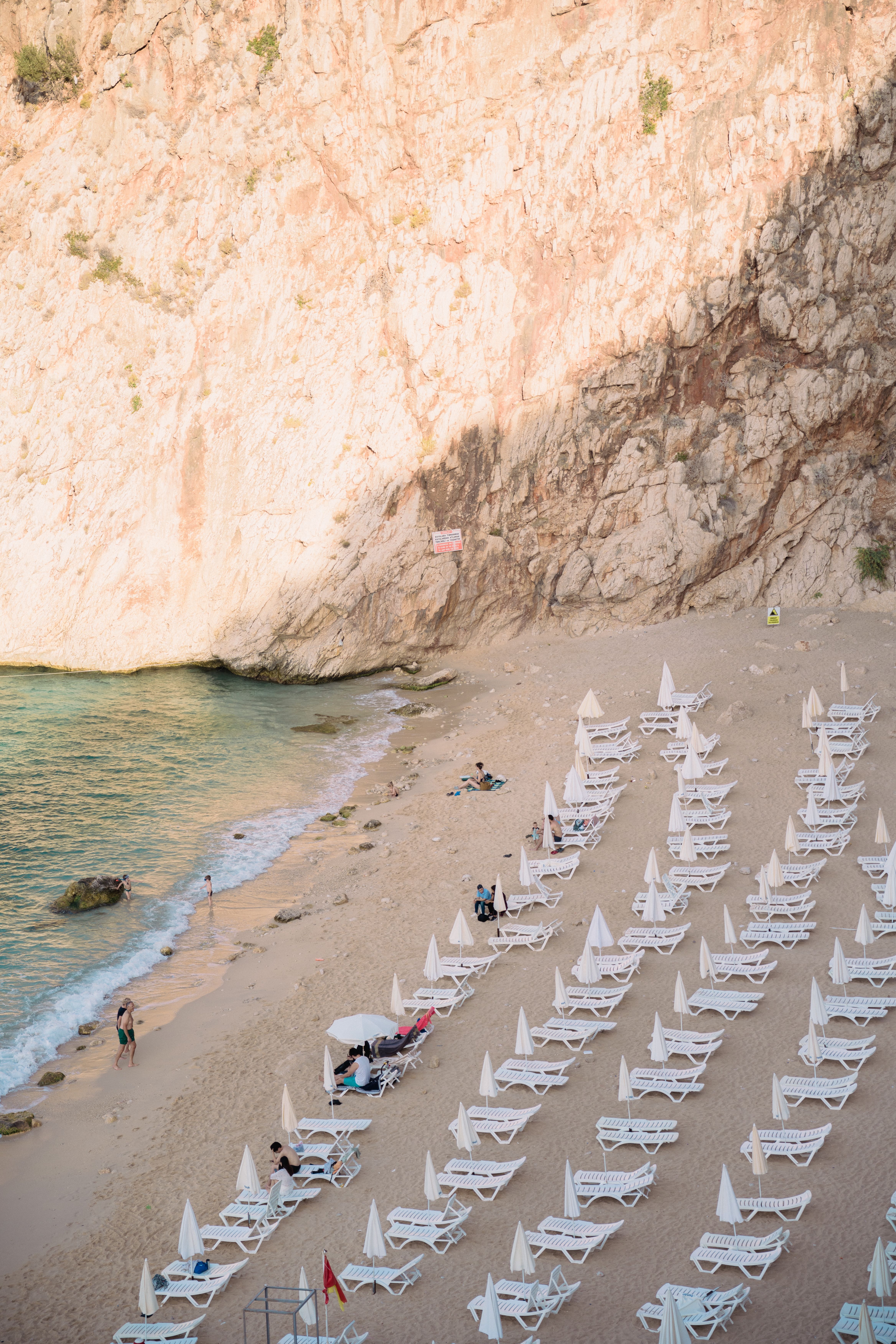 Rows of Sunbeds and Beach Umbrellas on Sea Shore · Free Stock Photo
