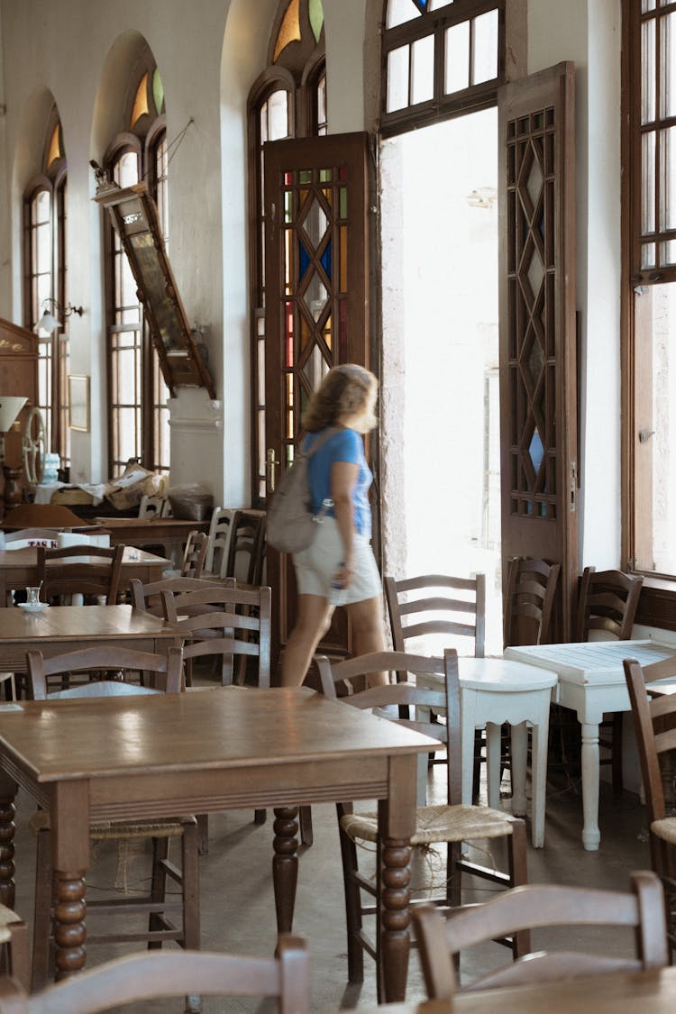 Woman Walking Out Of A Restaurant 