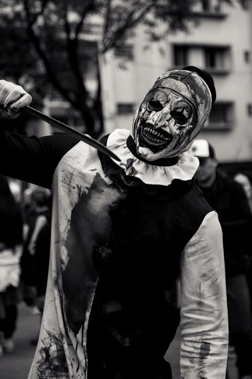 Man Wearing Scary Clown Costume in Black and White