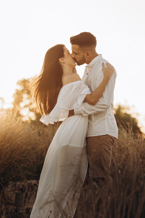 Couple Kissing on a Field