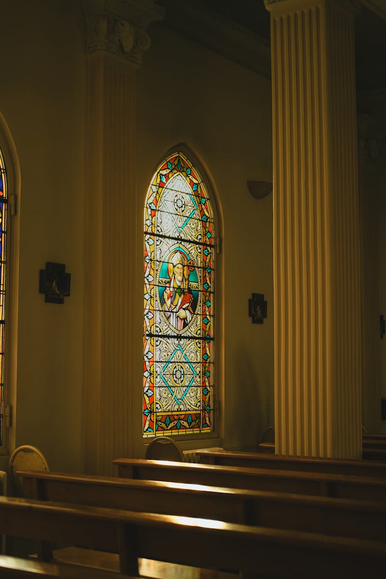 Stained Glass Window In A Church Depicting A Saint 