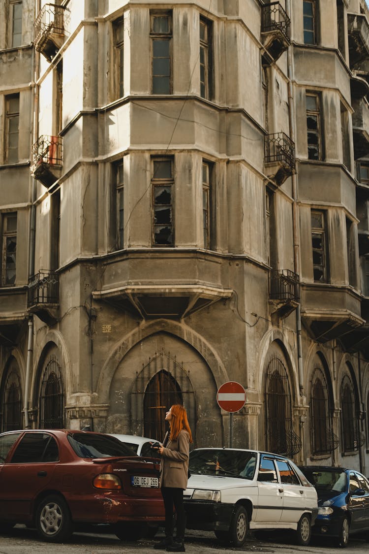 Woman In A City Looking At The Traditional Apartment Building In Ankara 