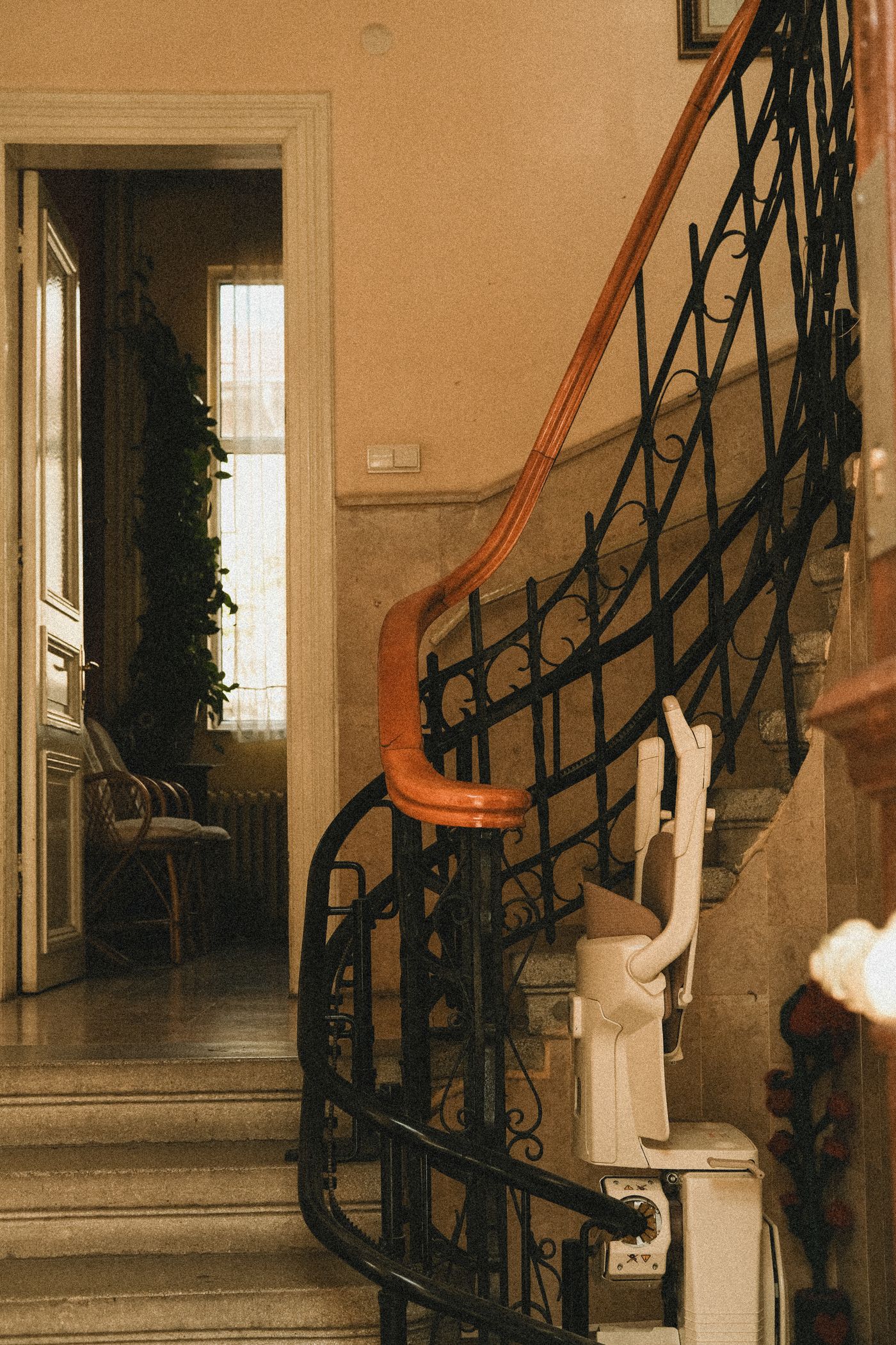 Stairlift mounted along a residential staircase railing