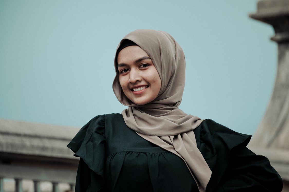 Young Woman in a Hijab Standing Outside and Smiling · Free Stock Photo