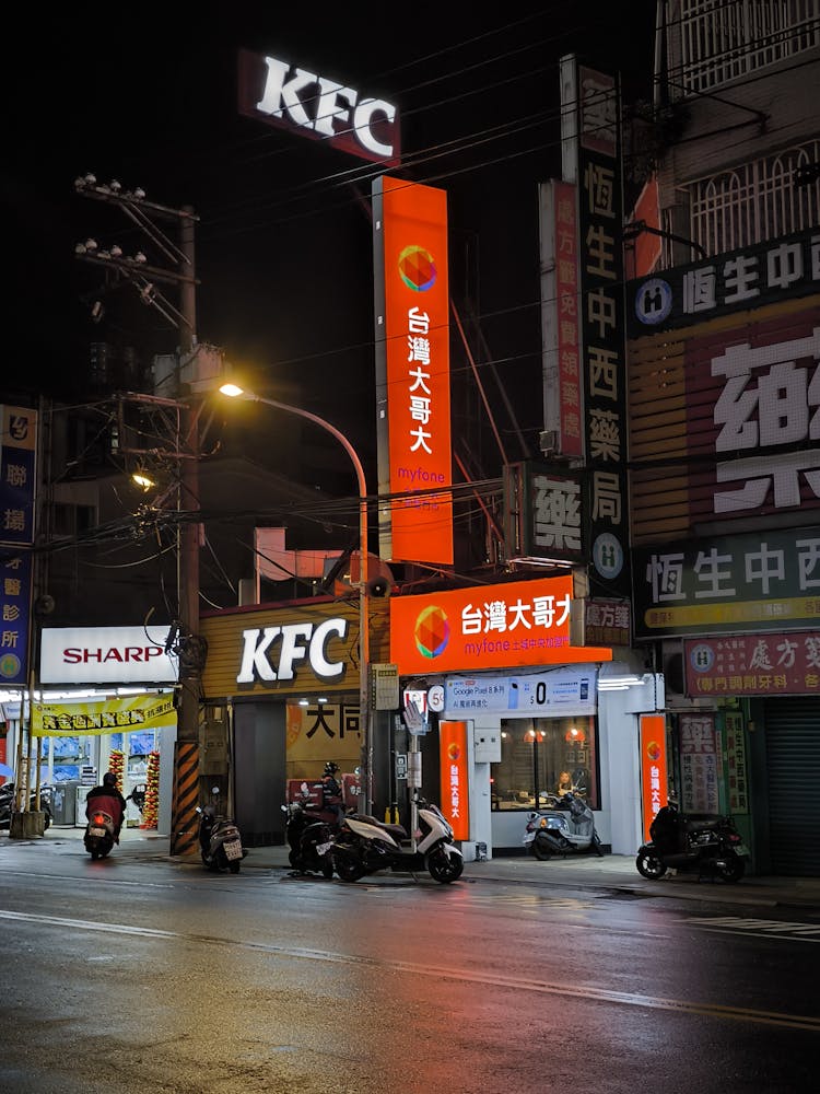 Facade Of KFC Restaurant In Downtown At Night